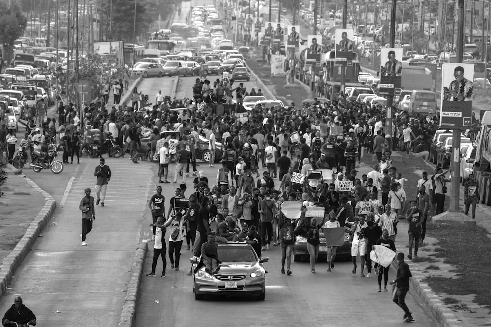 grayscale photo of people walking on street