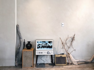 Black and white minimalist shot of a vintage television set in an empty modern room.