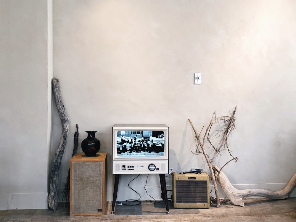 silver flat screen computer monitor on brown wooden table