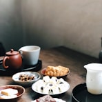 white ceramic mug on black ceramic plate