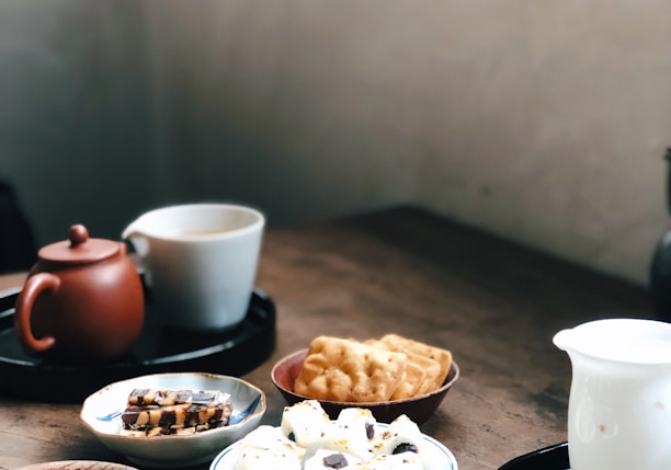 white ceramic mug on black ceramic plate