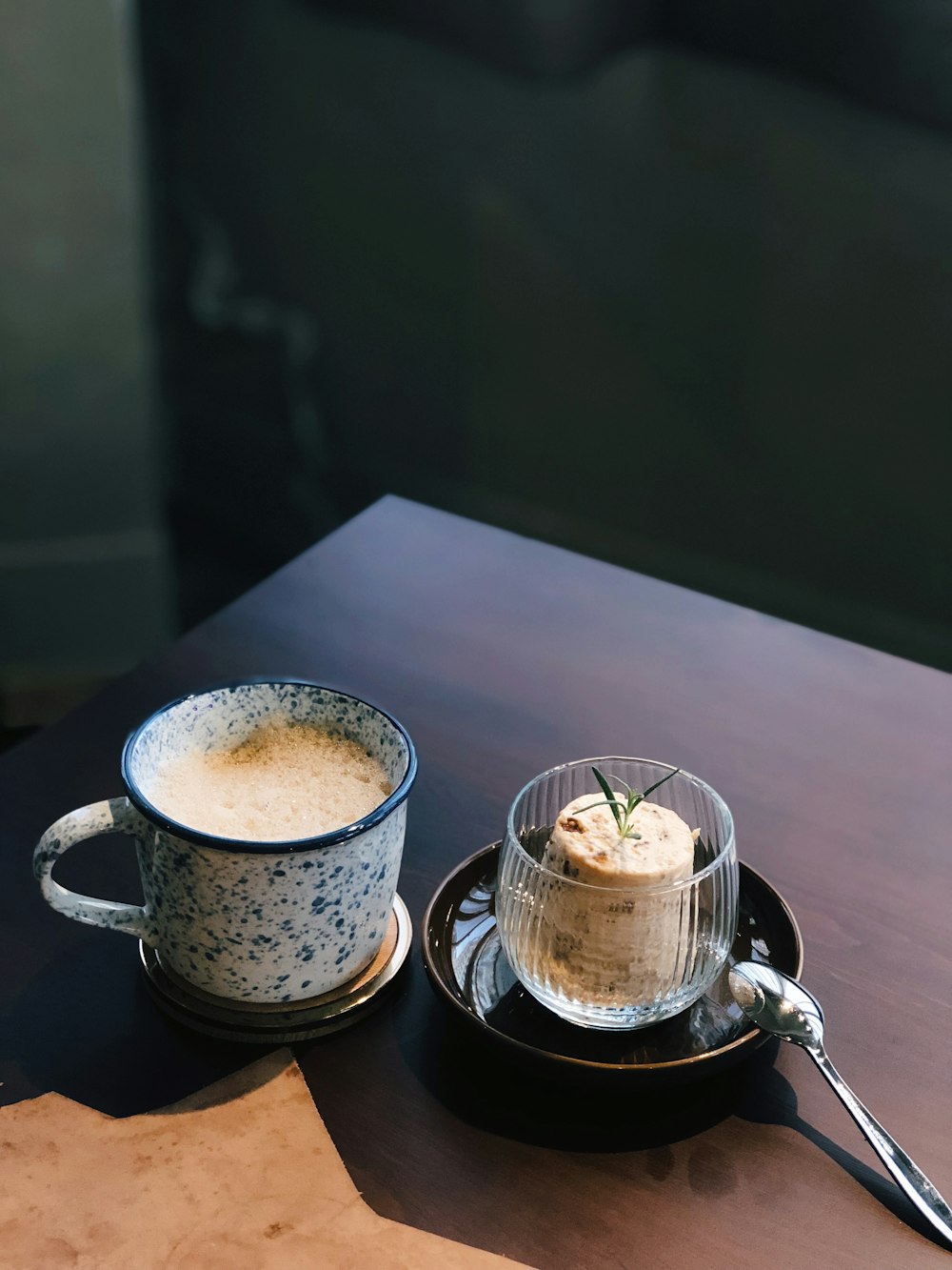 2 brown ceramic mugs on black ceramic saucer