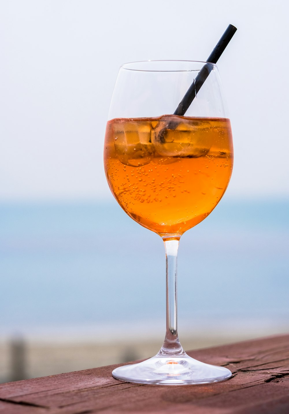 klares Weinglas mit Orangenflüssigkeit