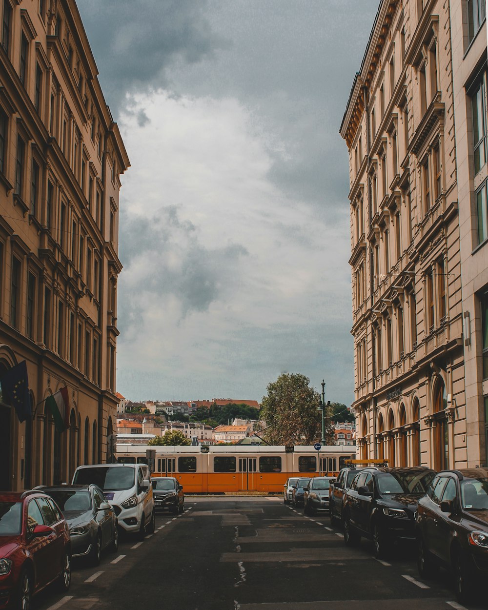 cars parked on side of road near buildings during daytime