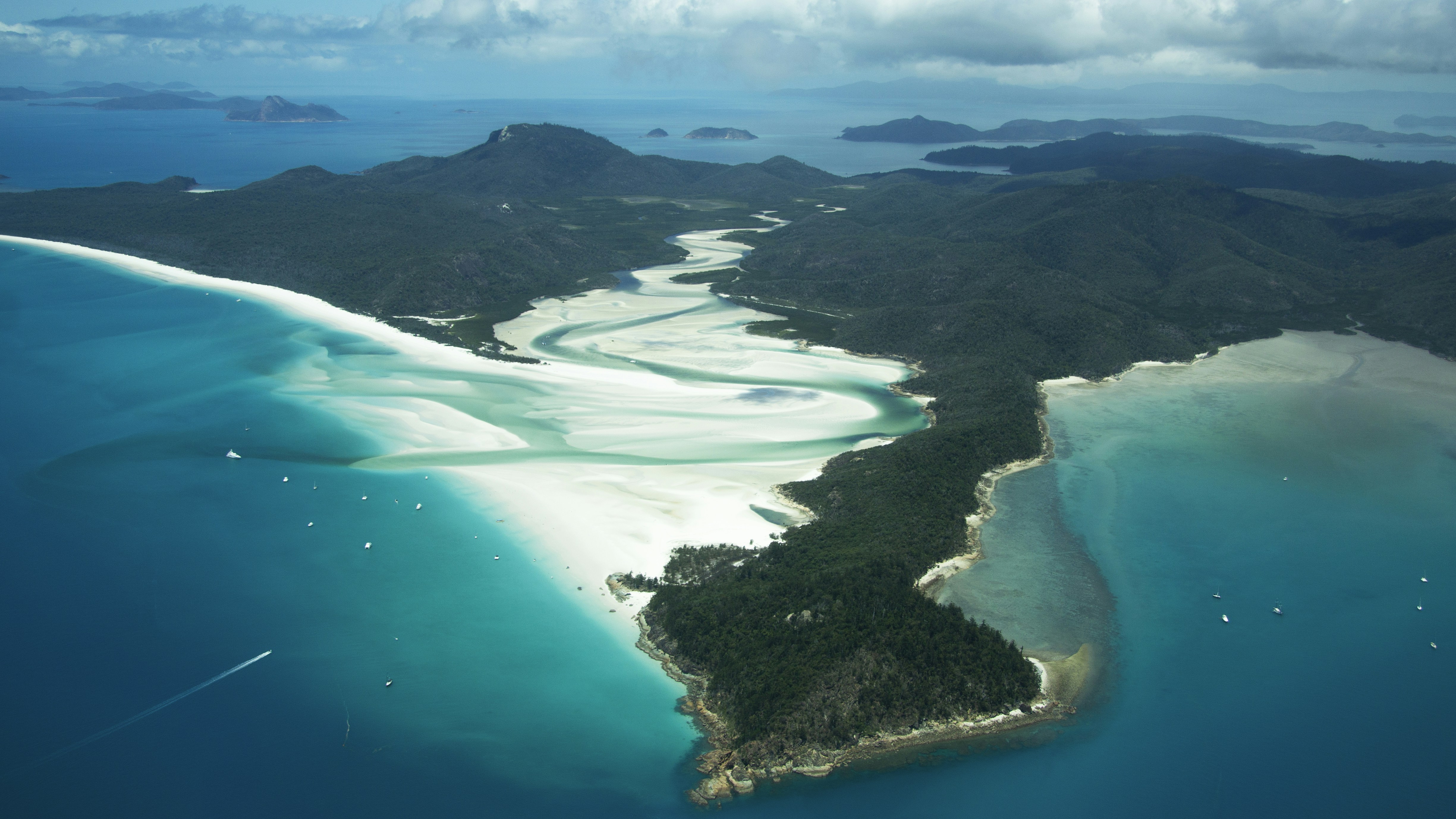 Aerial view of Whitehaven Beach's white silica sand swirling with turquoise water, Whitsunday Islands, Australia