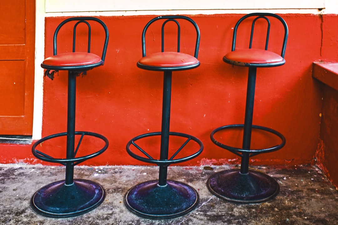 2 black metal bar stools