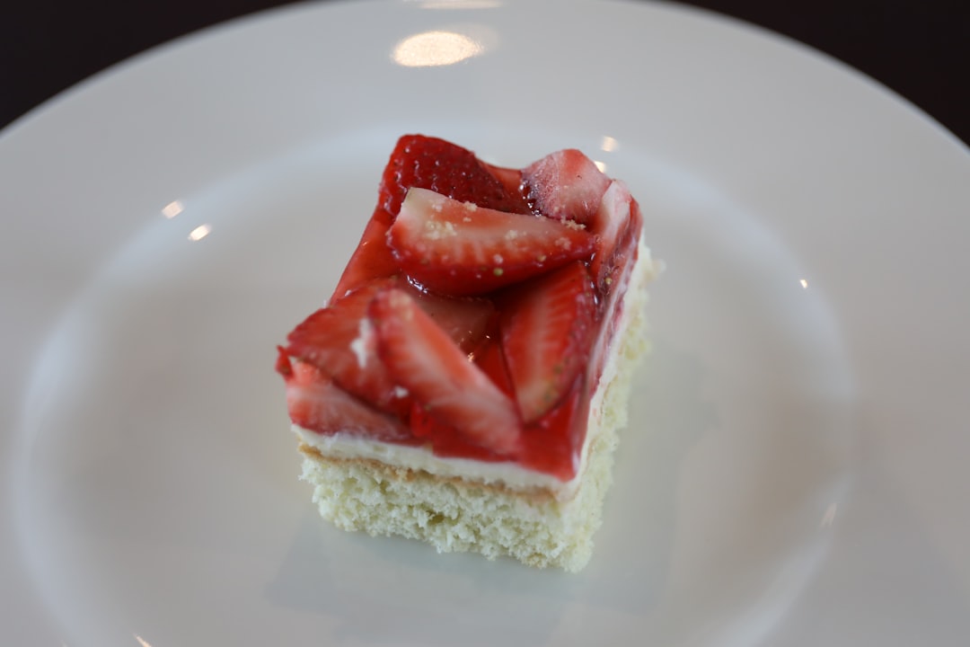 sliced strawberry on white cake