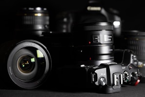 black nikon dslr camera on black surface