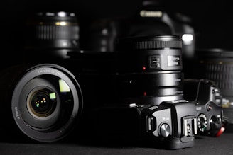 black nikon dslr camera on black surface