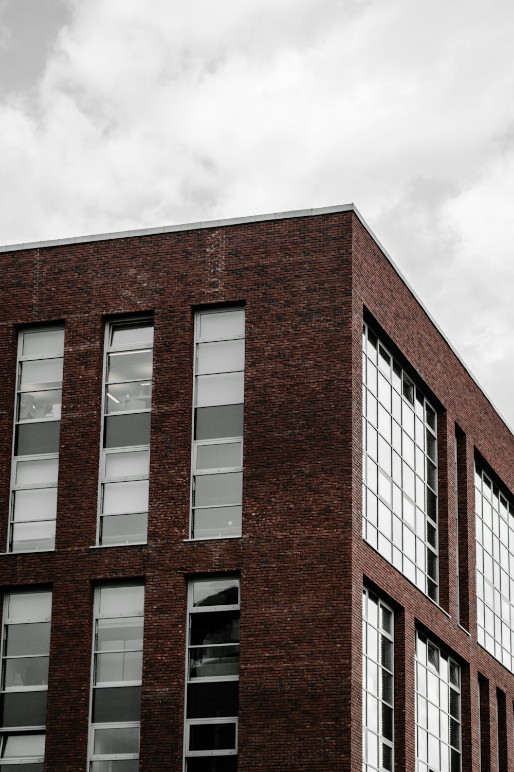 brown and white concrete building under white clouds during daytime