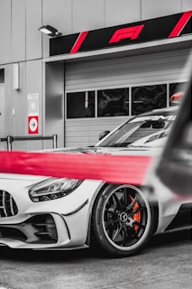 red and white sports car in grayscale photography