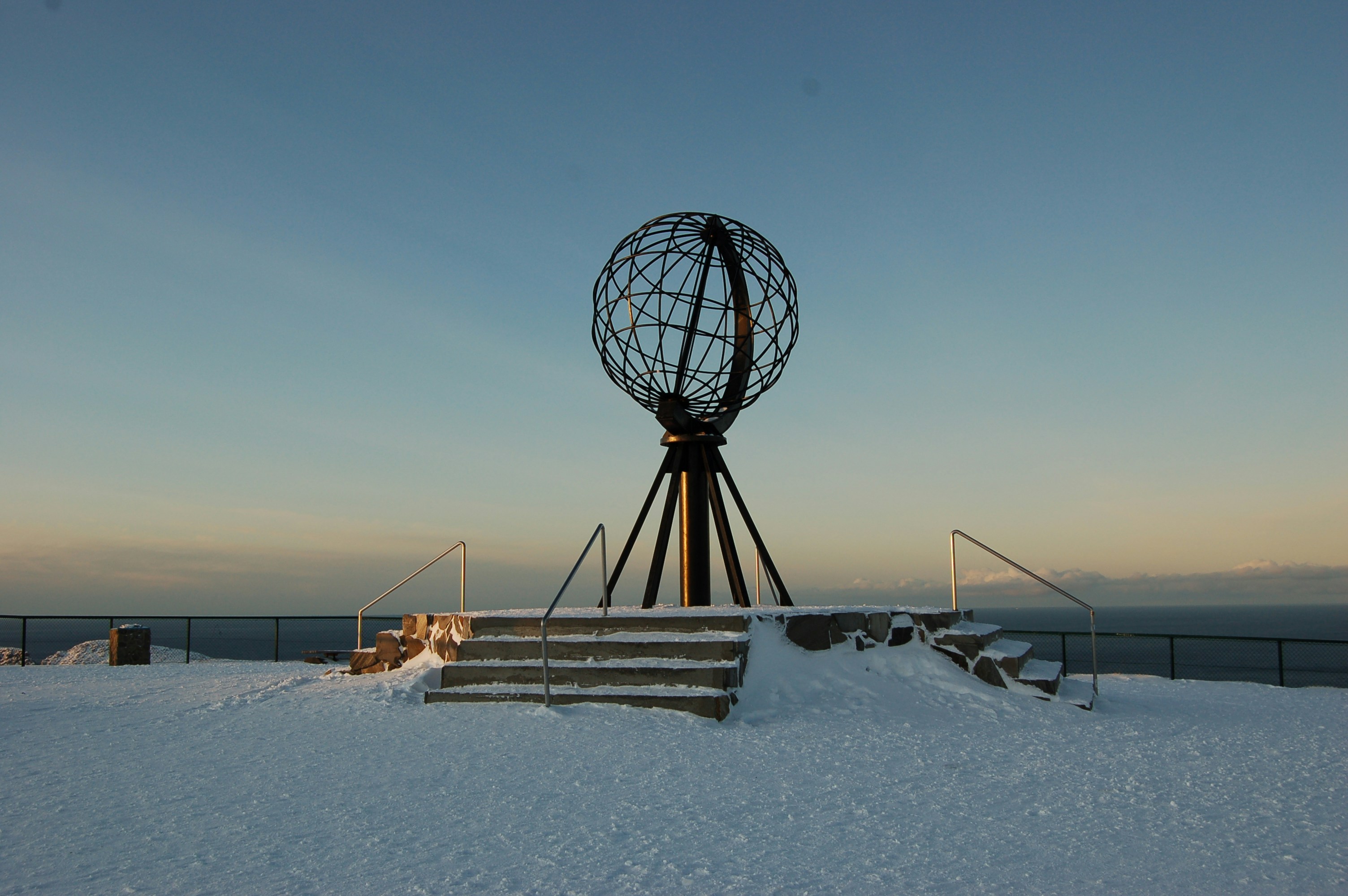 black metal ferris wheel on white snow covered ground during daytime