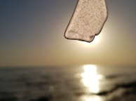 A close-up of polished sea glass reflecting sunlight.