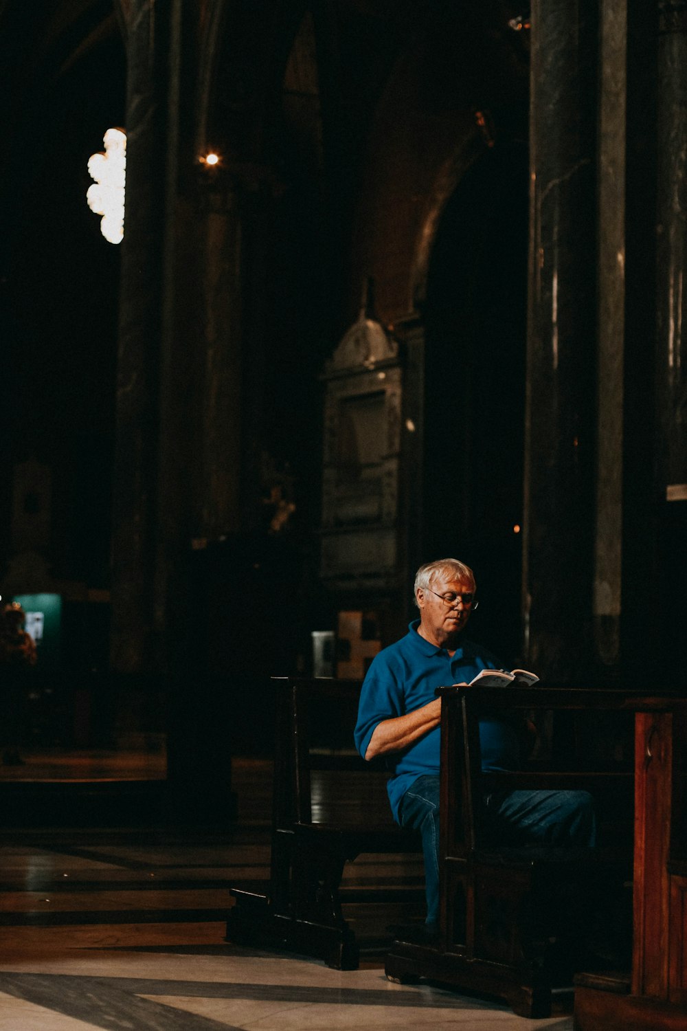 man in blue dress shirt sitting on chair