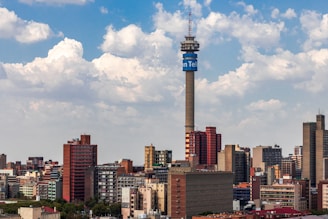 city skyline under blue and white cloudy sky during daytime