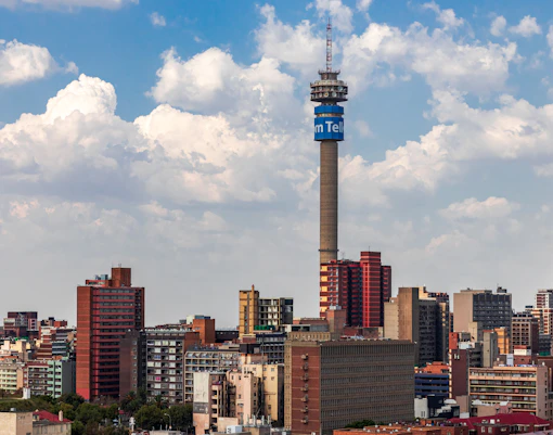 city skyline under blue and white cloudy sky during daytime