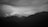 A captivating photograph showcasing a vibrant landscape with layered mountains under a dramatic sky.