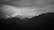 A captivating photograph showcasing a vibrant landscape with layered mountains under a dramatic sky.