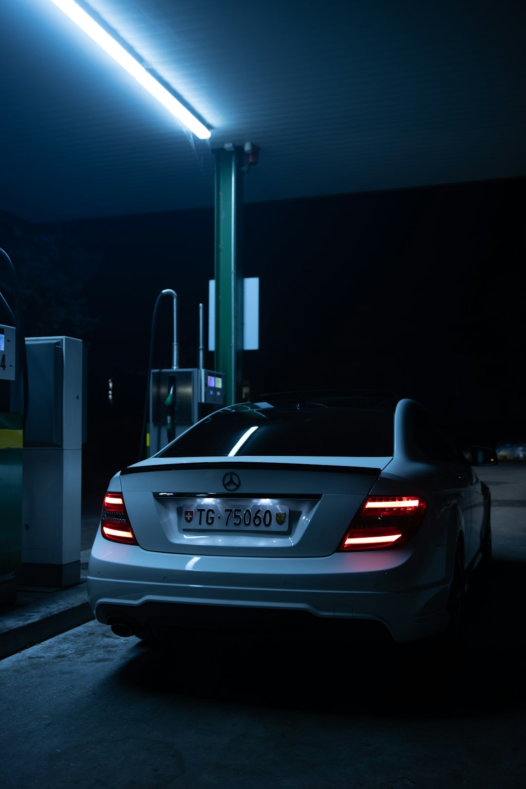 silver bmw m 3 parked on parking lot during night time