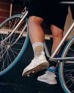 person wearing white and brown nike sneakers