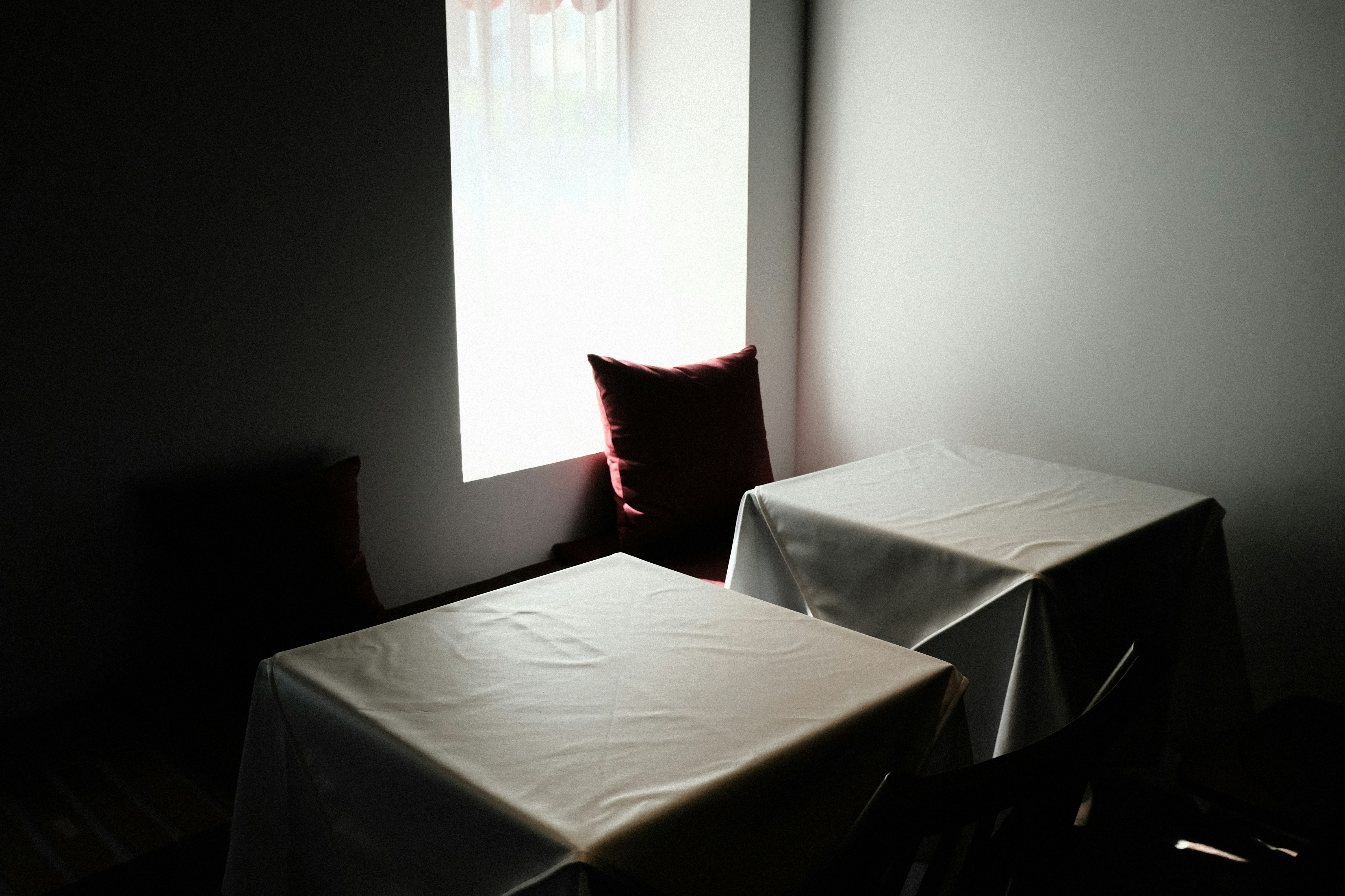red throw pillow on white table