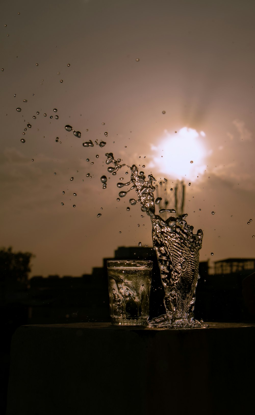 a glass of water splashing out of it