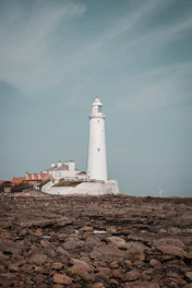 white lighthouse under blue sky during daytime in whitley bay