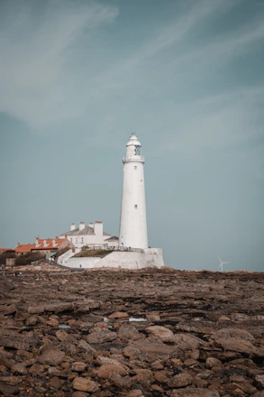 white lighthouse under blue sky during daytime in whitley bay