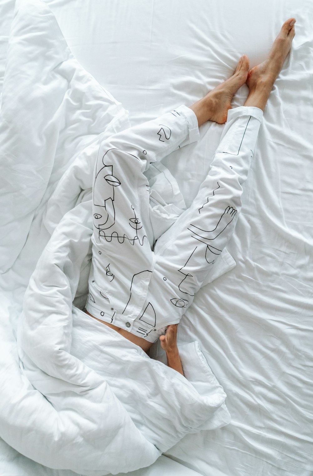 person in white robe holding white textile