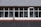 A building facade featuring a tiled roof and large rectangular windows. The windows reveal a glimpse of the interior, including walls and possible signage. The tiles on the roof are arranged in a neat, organized pattern, and there is a downspout running vertically between the windows.