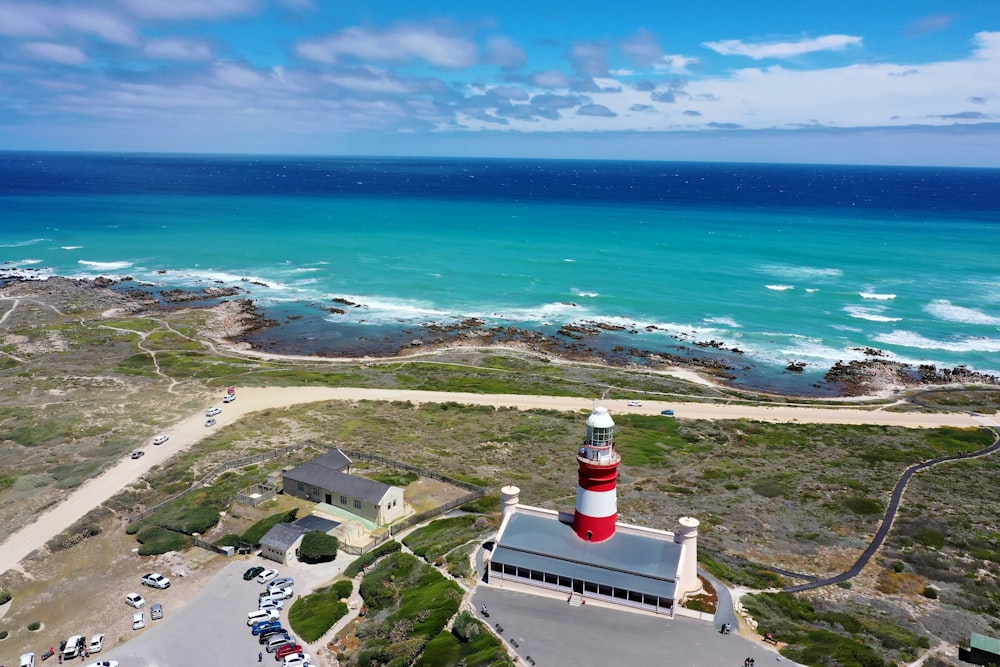 white lighthouse near body of water during daytime