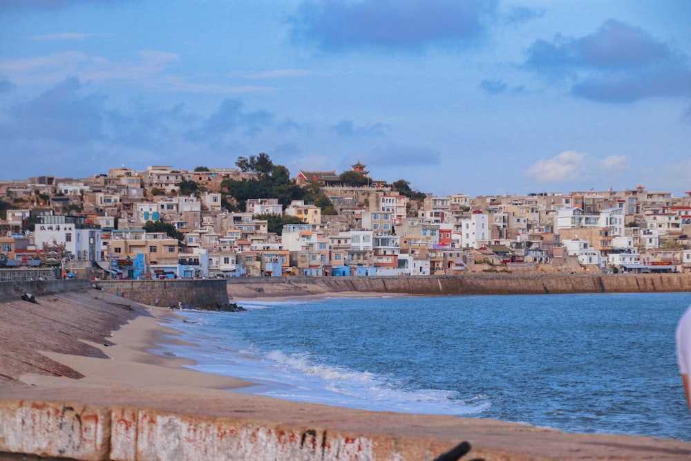 white and brown buildings near sea under blue sky during daytime