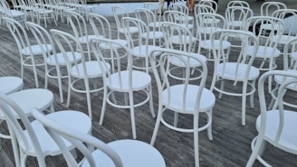 A collection of lounge chairs arranged for an outdoor event.