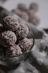 brown and white round fruits in clear glass bowl