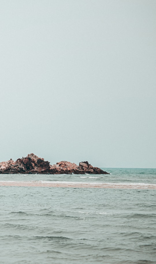 brown rock formation on sea during daytime in Cherating Malaysia