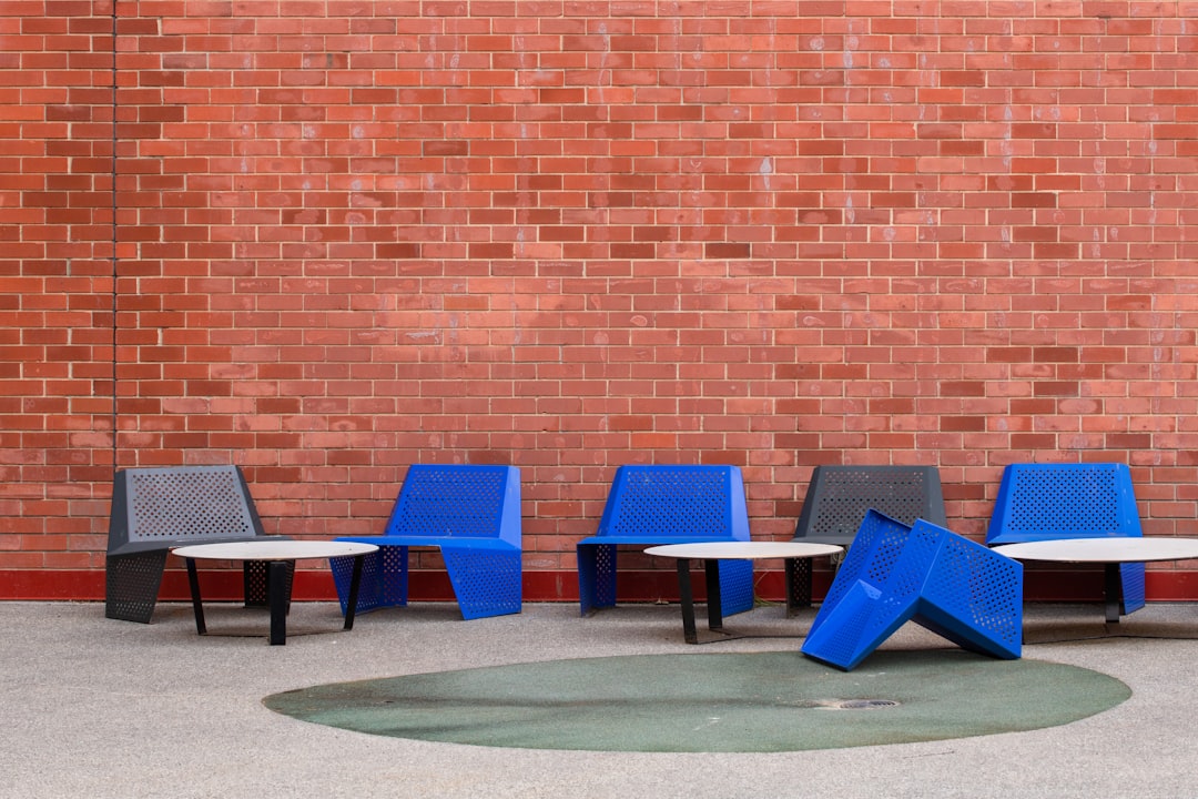 blue and black chairs on green grass field