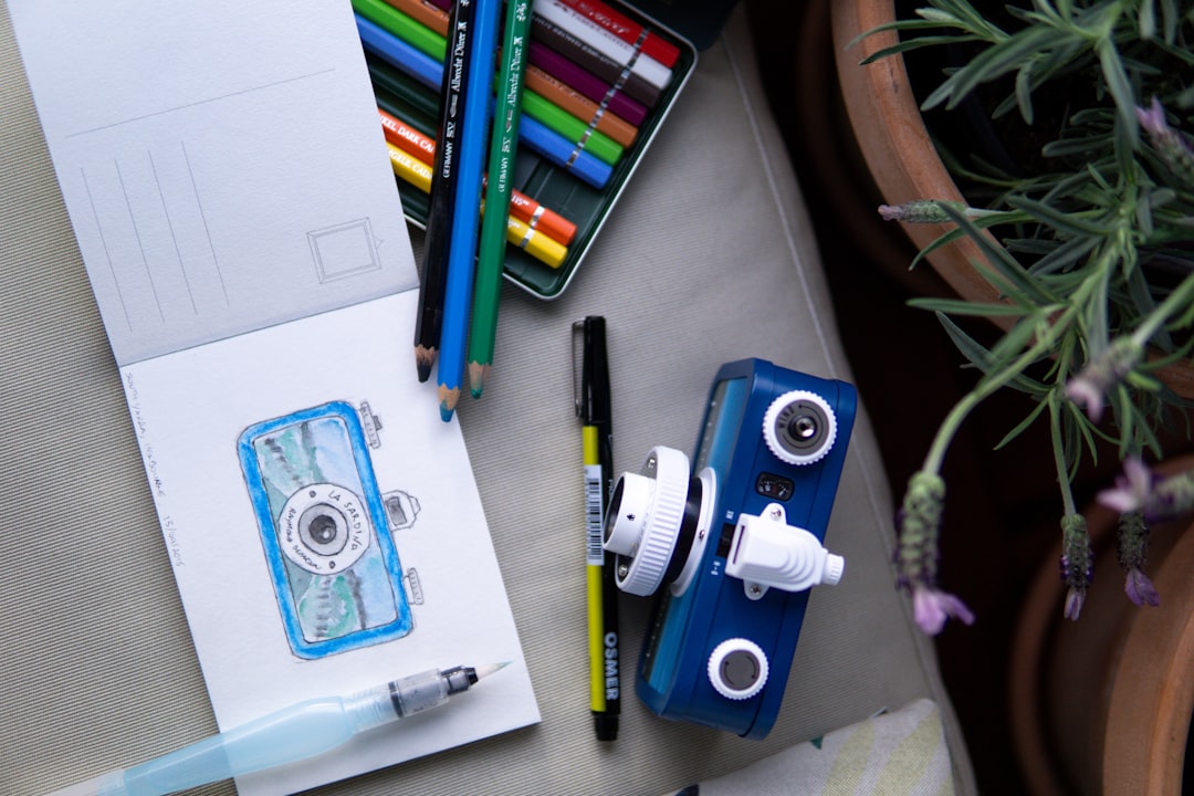 blue and white camera on white printer paper