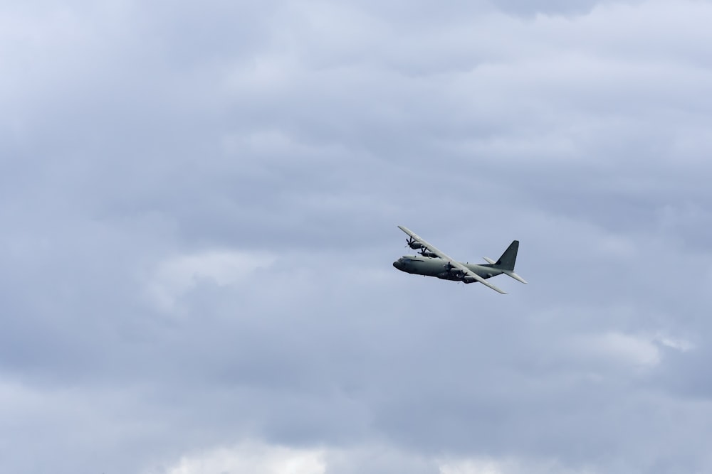 white and black jet plane in mid air during daytime