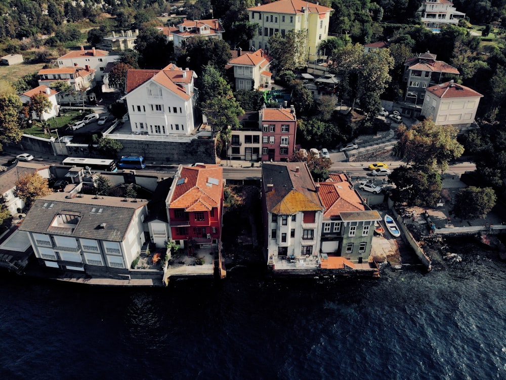 aerial view of houses near body of water during daytime