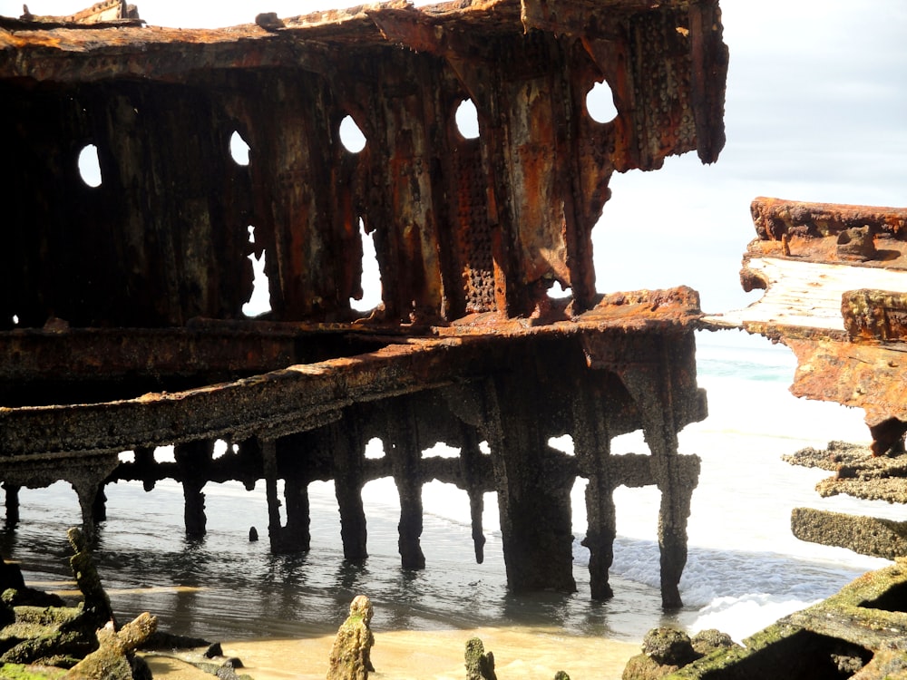 brown wooden post on body of water during daytime