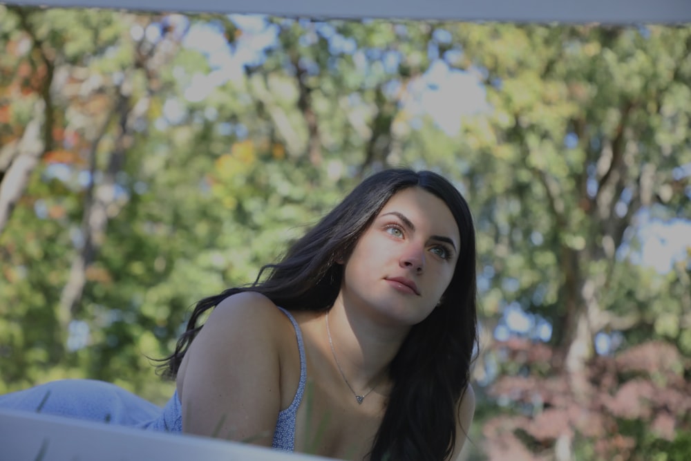 a woman sitting on a bench in a park