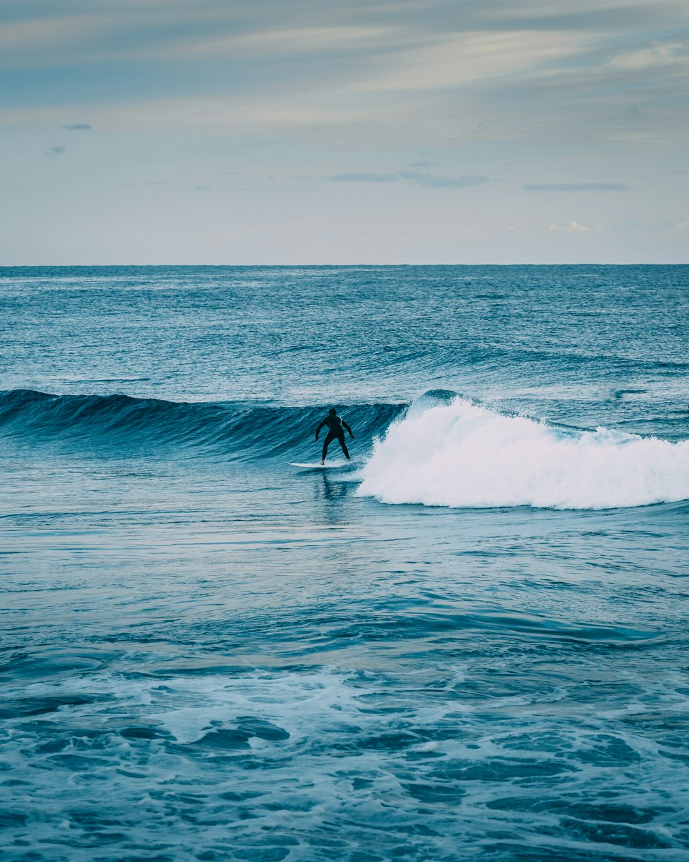 person surfing on sea waves during daytime