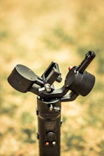 Close-up of a camera smoothly moving on a gimbal with a blurred cityscape background.