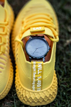yellow adidas sneakers on green grass