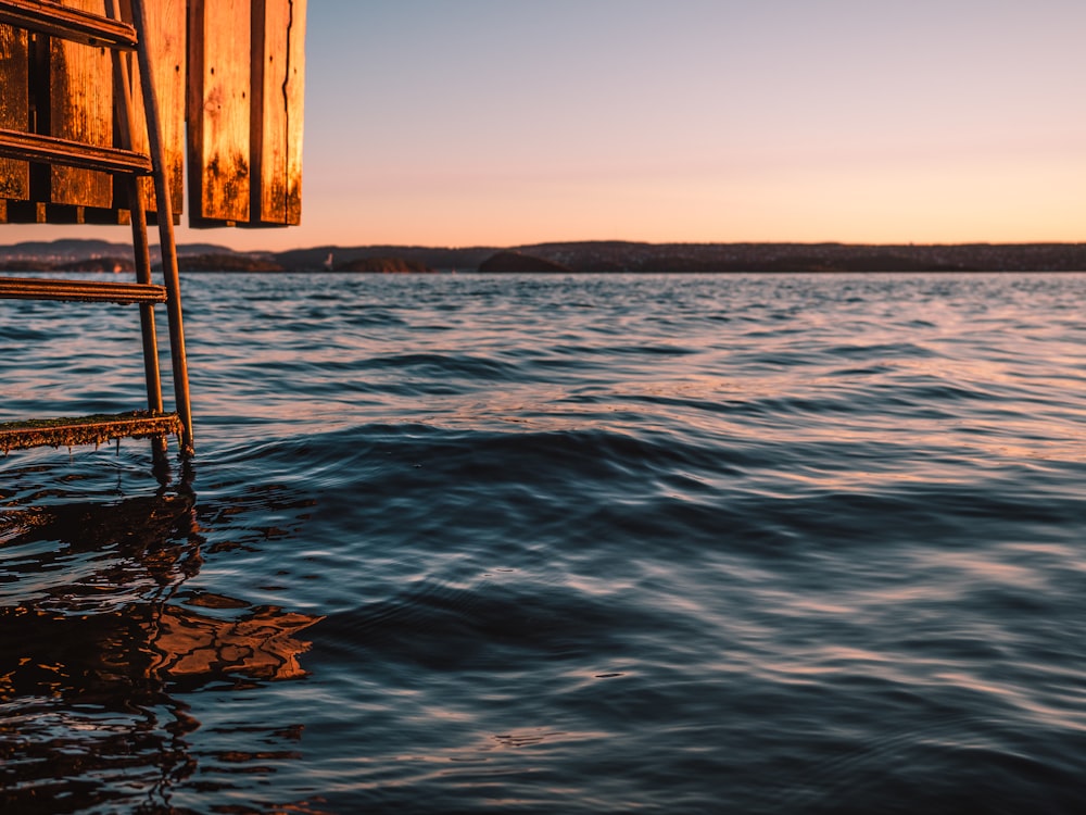 brown wooden dock on blue sea during daytime