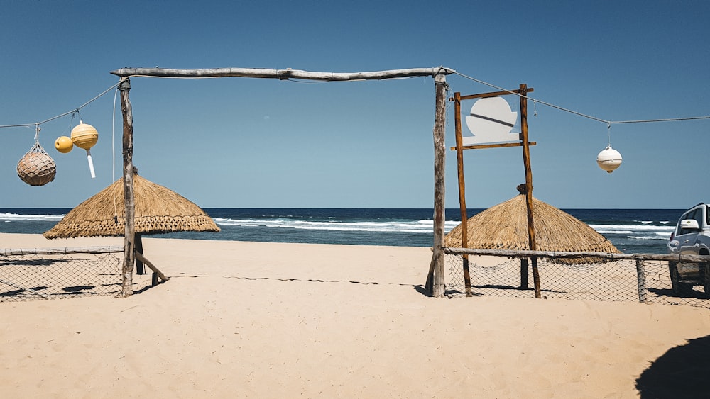 brown wooden beach house on white sand beach during daytime