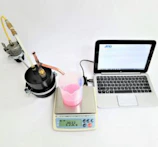 Zinc bromide powder carefully measured on a precision scale in a technical lab environment.