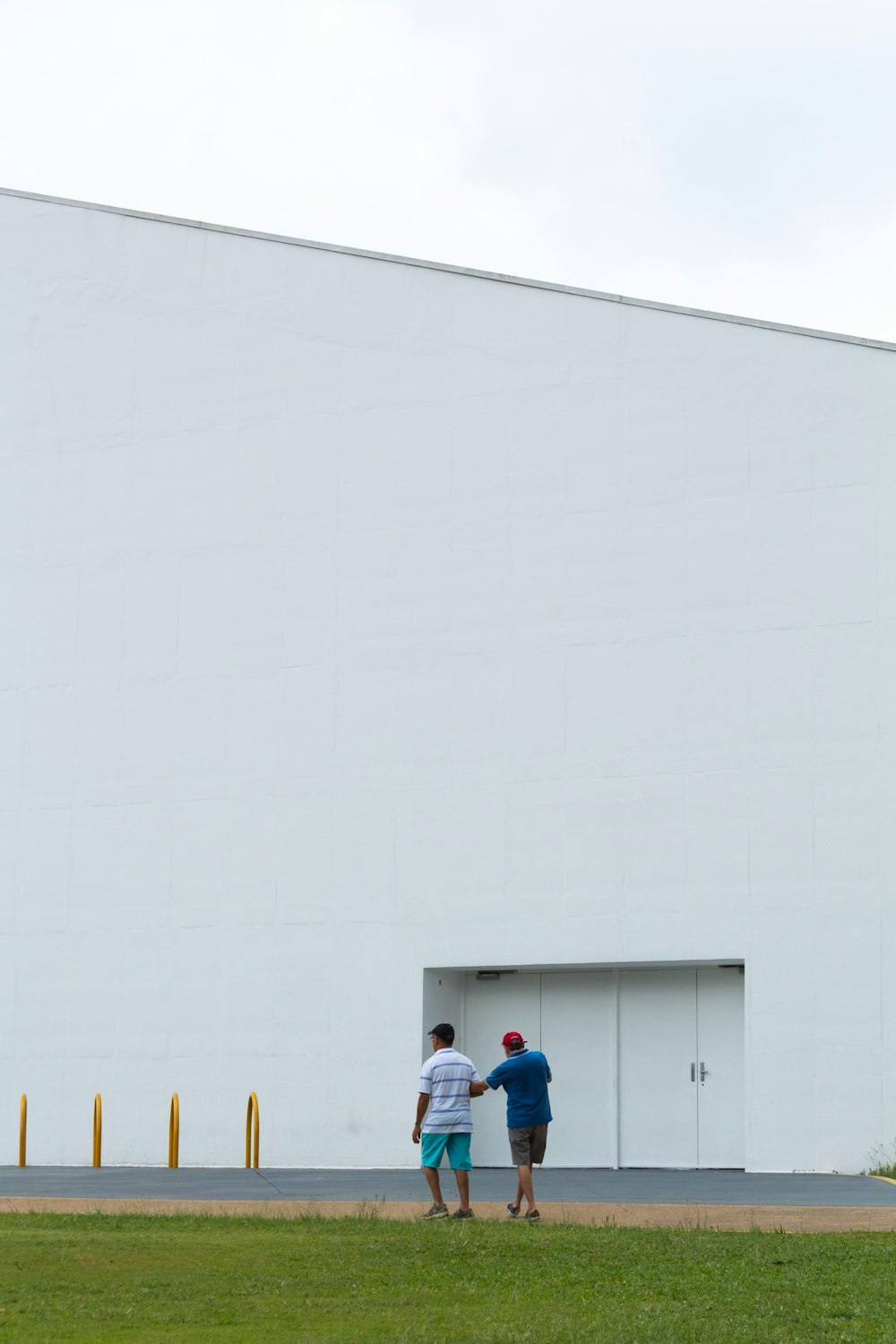 people standing near white wall during daytime
