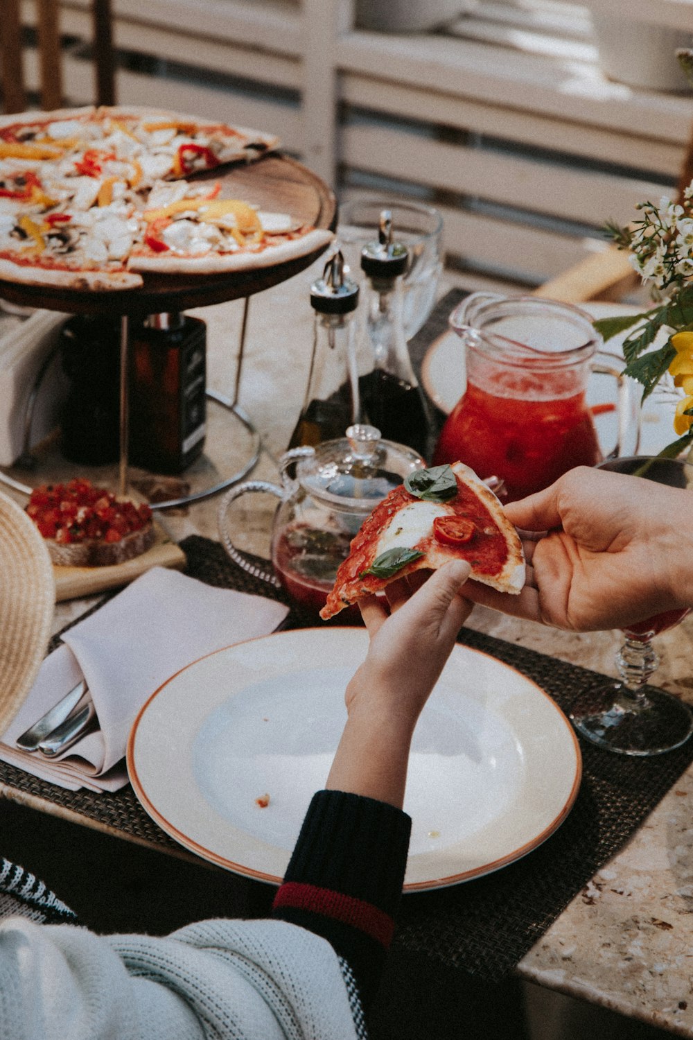 person holding a bread with red sauce