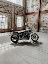 A sleek motorcycle jacket hanging on a rustic wooden wall, bathed in soft natural light.